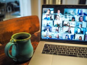a mug next to a laptop on a group video call