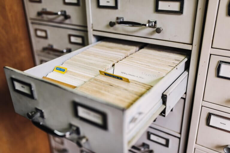 an open file cabinet with lots of folders and papers for document storage