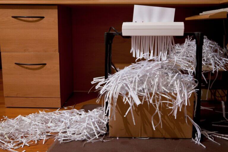 a paper shredder shredder with a pile of shredded paper