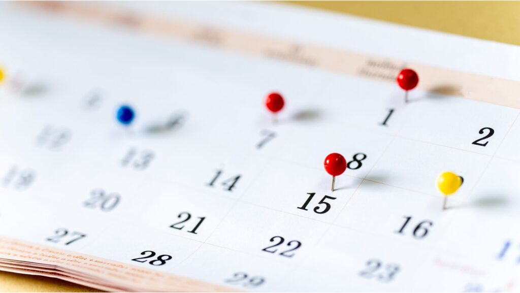 a calendar with pins on certain dates